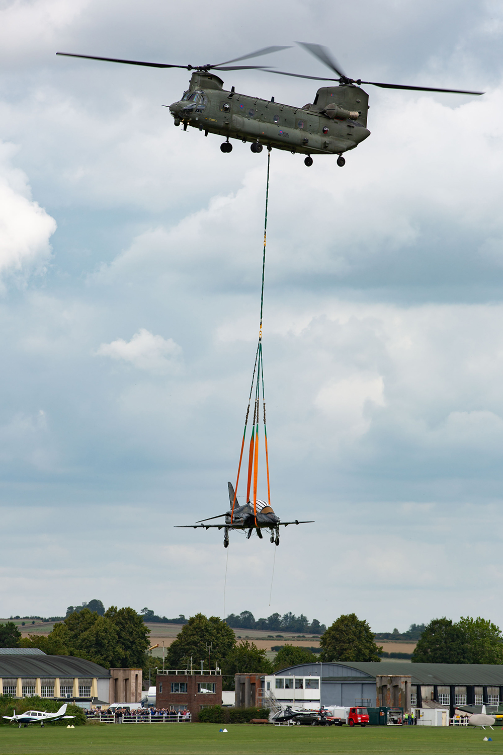 The T1 Hawk arrives over Old Sarum airfield, underslung from a No. 27 Squadron Chinook, based at RAF Odiham