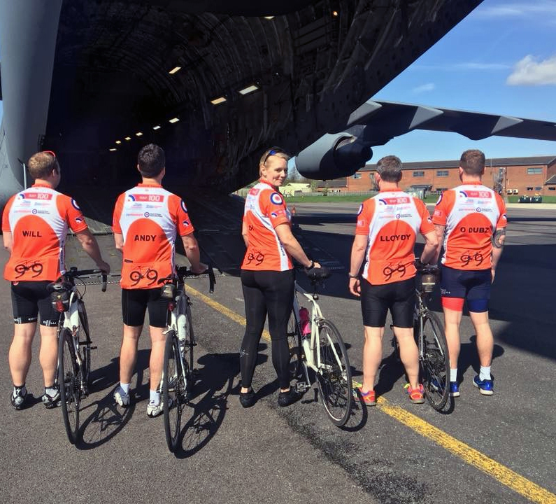 Team members stand aft of a C-17A Globemaster III, of Number 99 Squadron, showing the reverse side of their jerseys