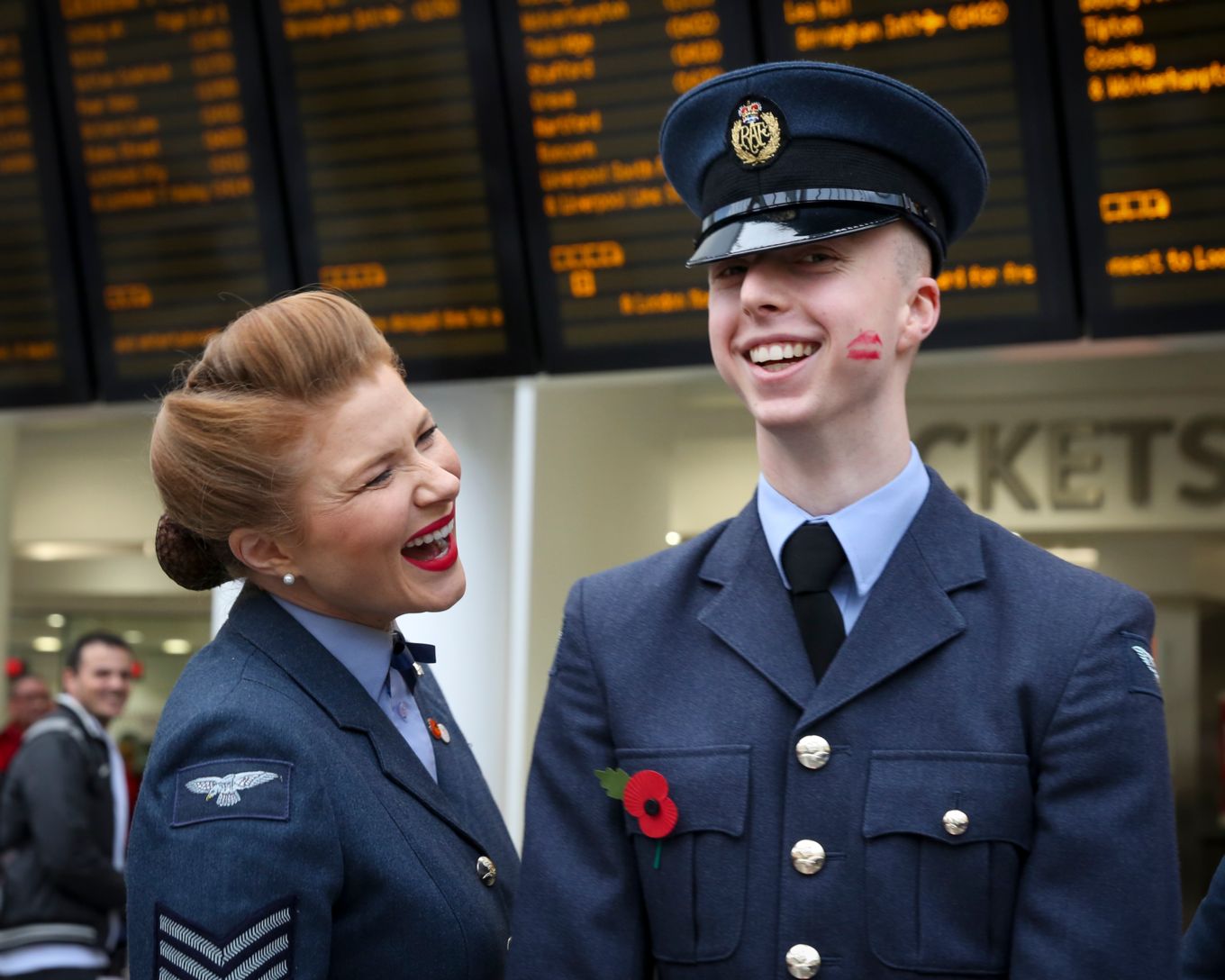 Airman with lipstick kiss on cheek from one of the D Day Darlings