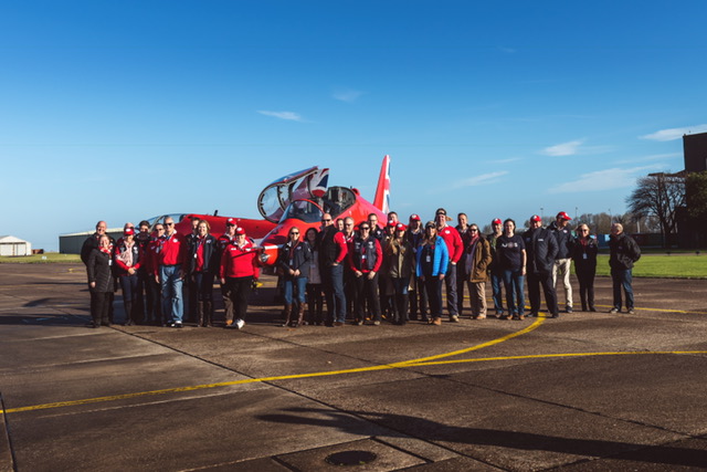 Beaujolais Run participants gather around Red Arrows jets at RAF Scampton.