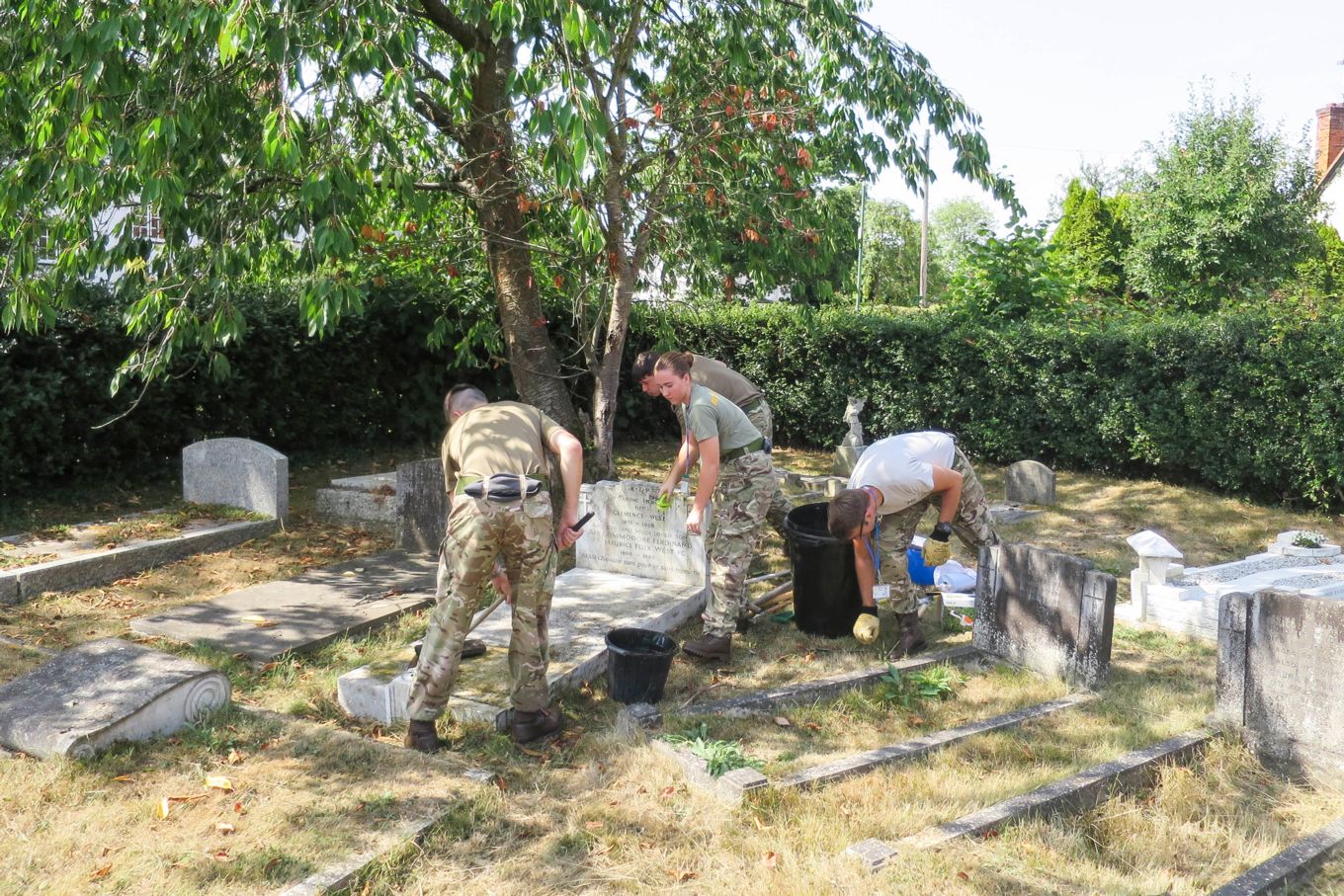 8 Sqn personnel tidying grave