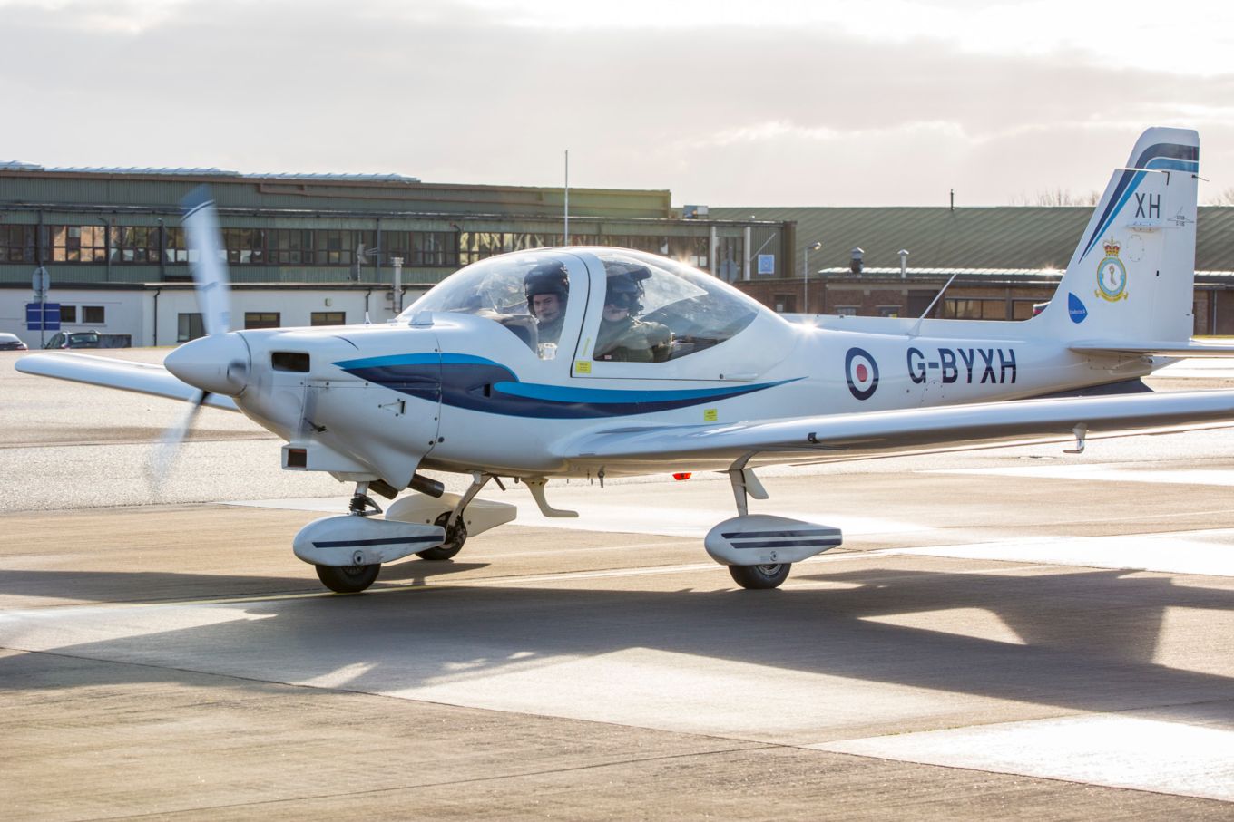 Flt Lt Latchem and 16 Sqn Student return from a training sortie in a Grob Tutor aircraft