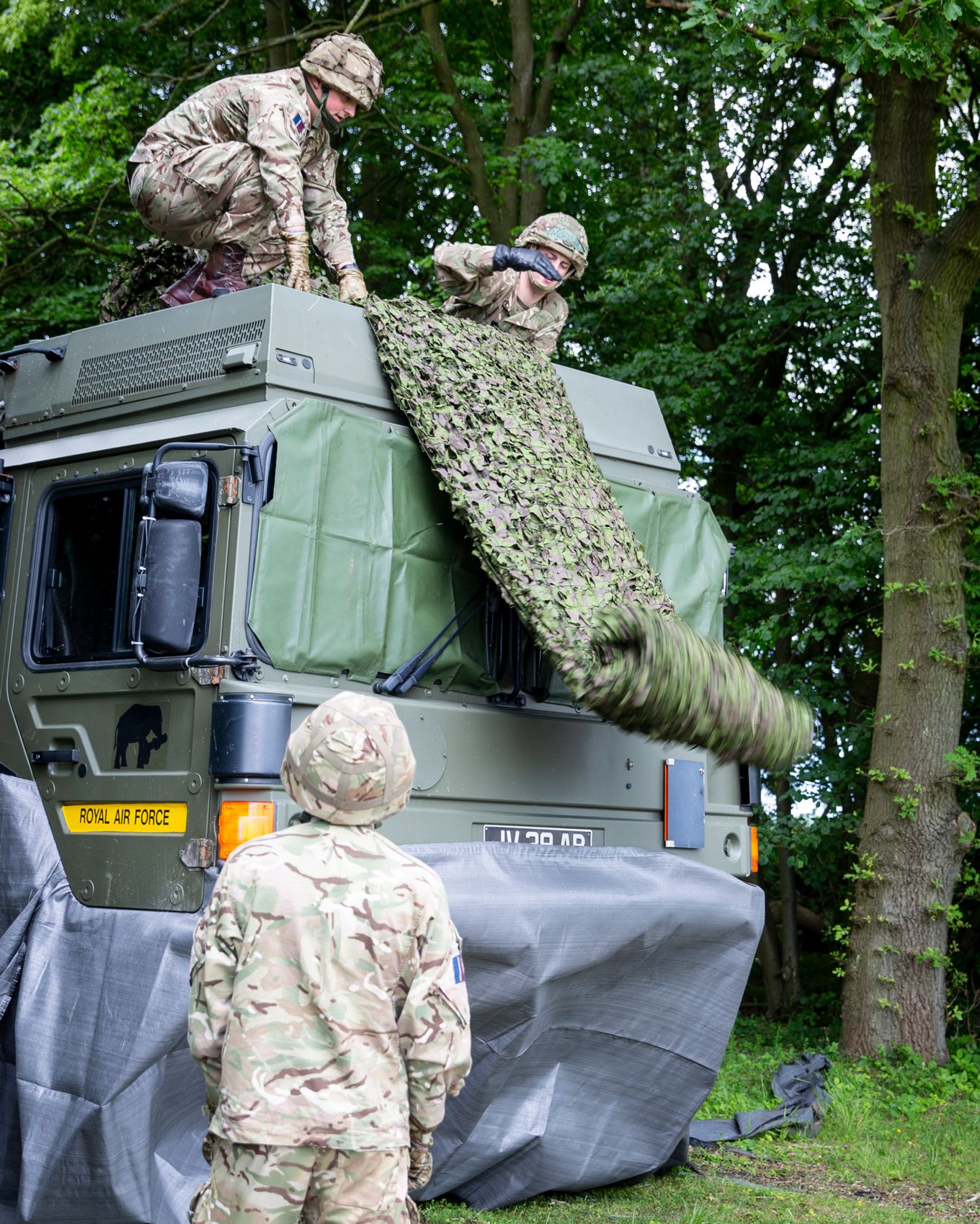 Camouflage netting is applied to the truck