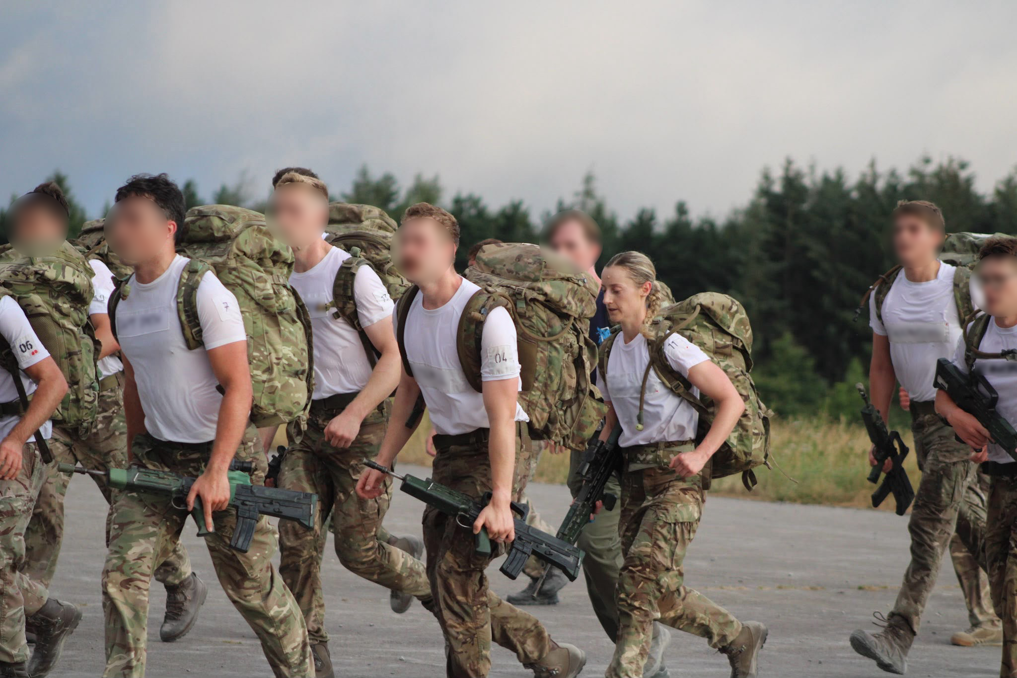 Flt Lt Alice running with other candidates on the course in gear.