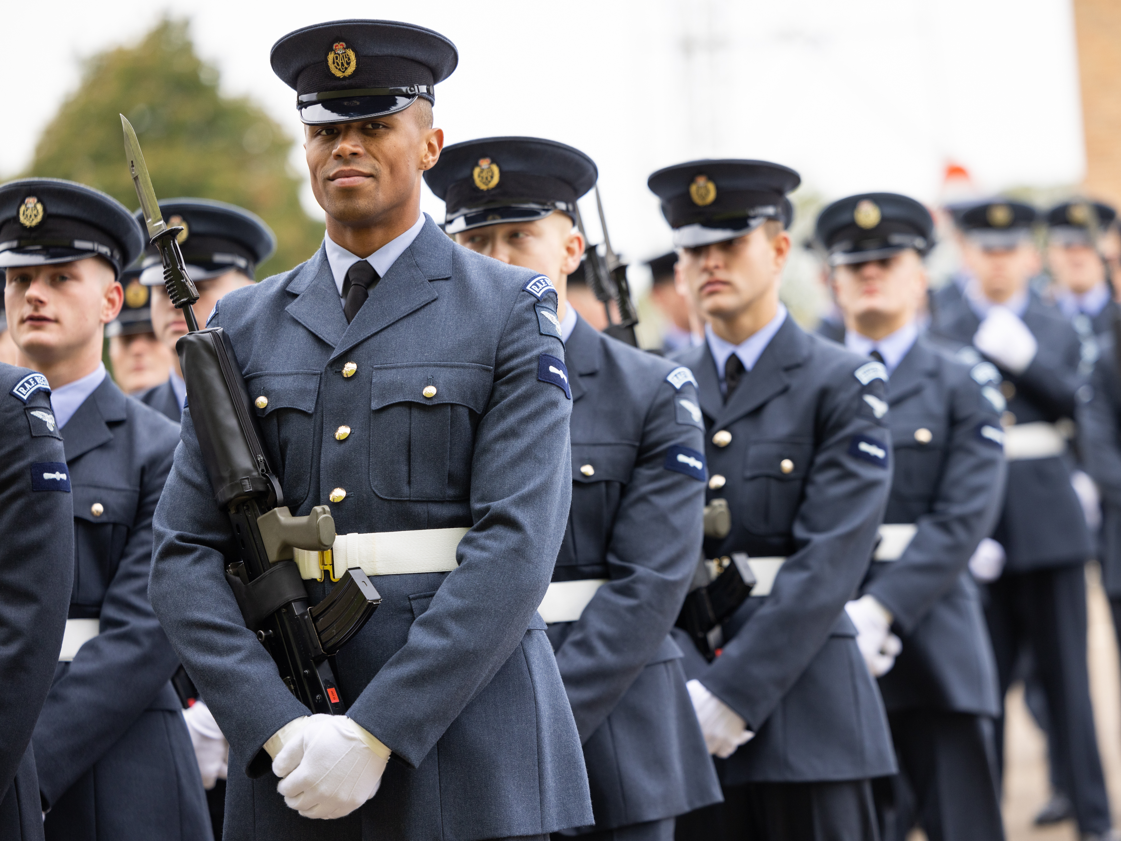 Side view of personnel marching in line during a parade. 