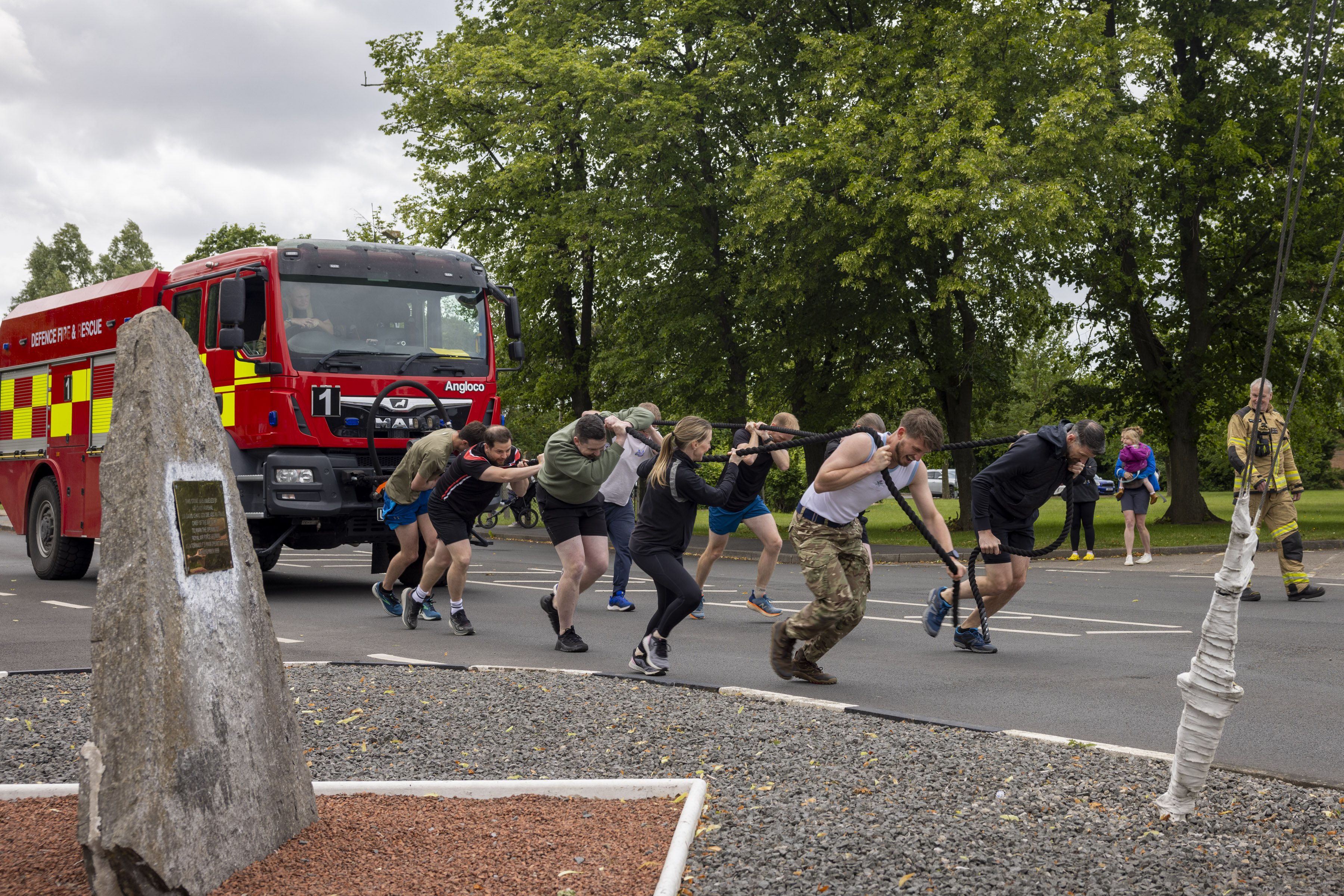 Personnel pulling a fire engine