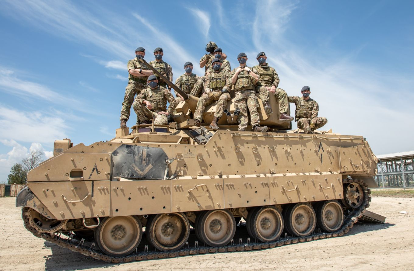 RAF Regiment personnel sit on top of a US Army’s Bradley Infantry Fighting Vehicle.