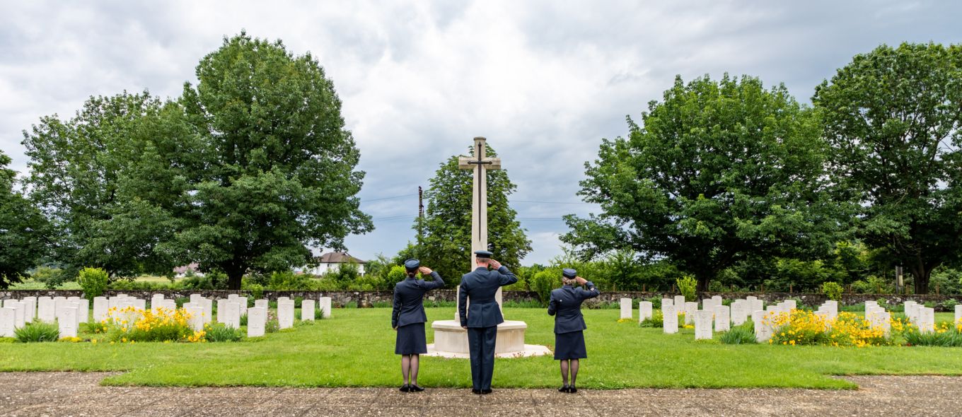 Personnel salute the memorial.
