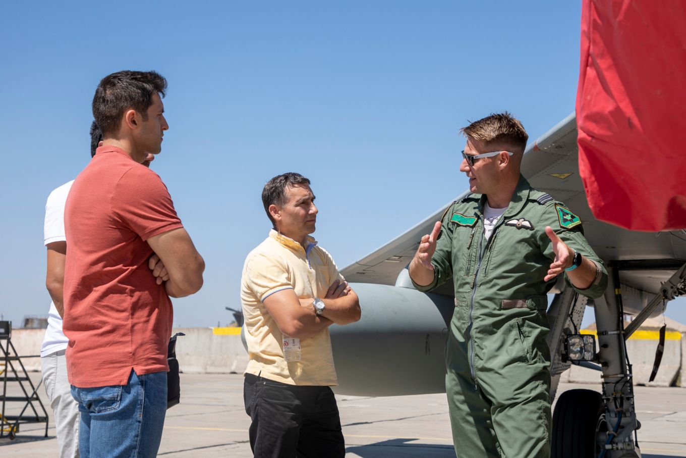 Romanian and RAF Pilots stand in discussion by a Typhoon. 