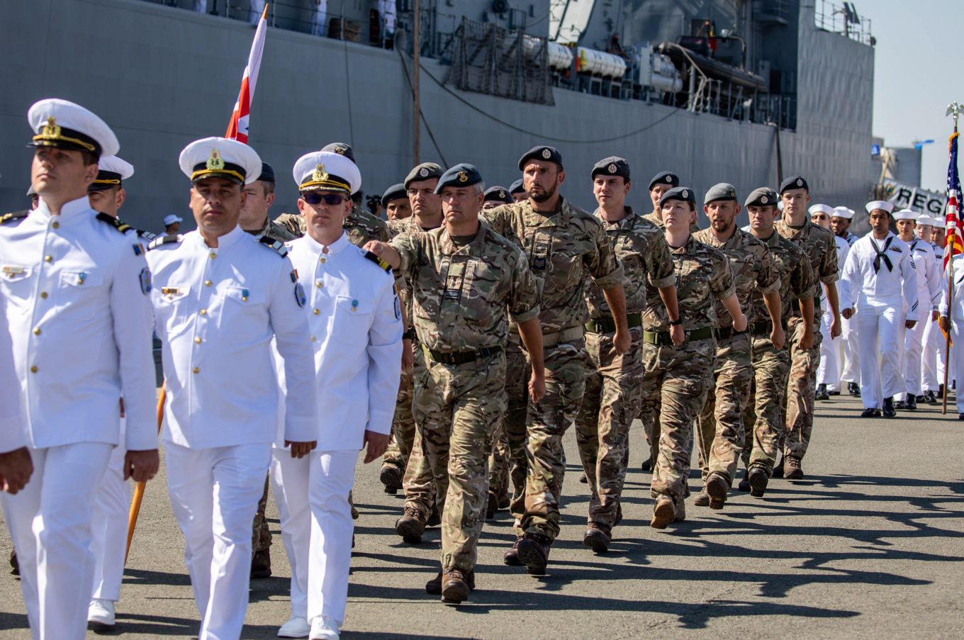 Navy and RAF personnel march in parade. 
