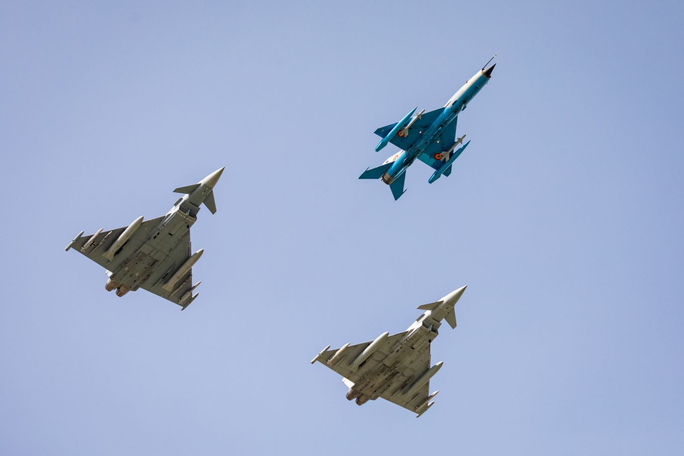 RAF Typhoon, German Eurofighter and Romanian MIG 21 LanceR fly in formation.