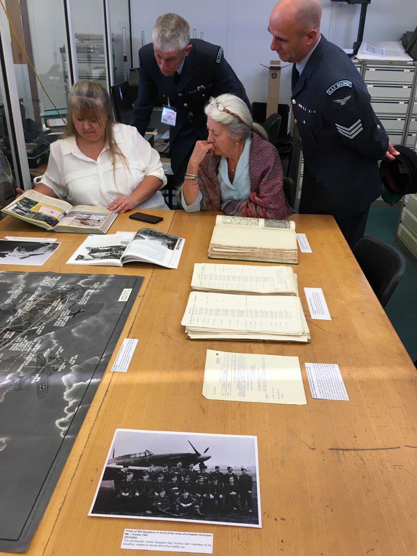 From left to right: Kate Whitworth, Andy Ham, Anne Holmes and Nick Woolmer looking over records at the RAF Museum in Hendon.