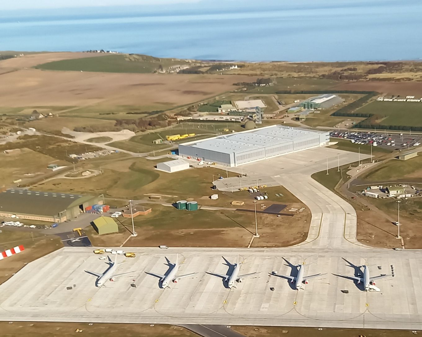 Poseidon (P-8A) lined up on the airfield - aerial view.