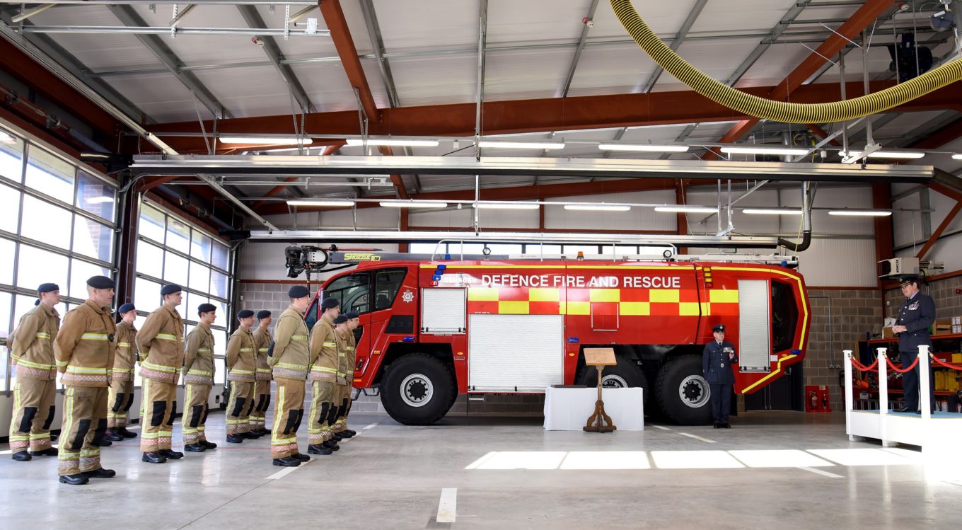 RAF Firefighters graduate infront of fire service vehicle