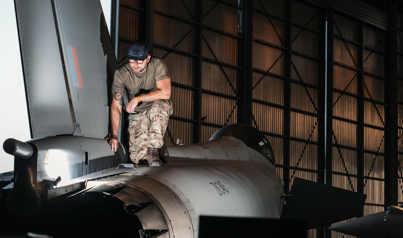 Member of 1(F) Squadron performs maintenance checks on top of a Typhoon.