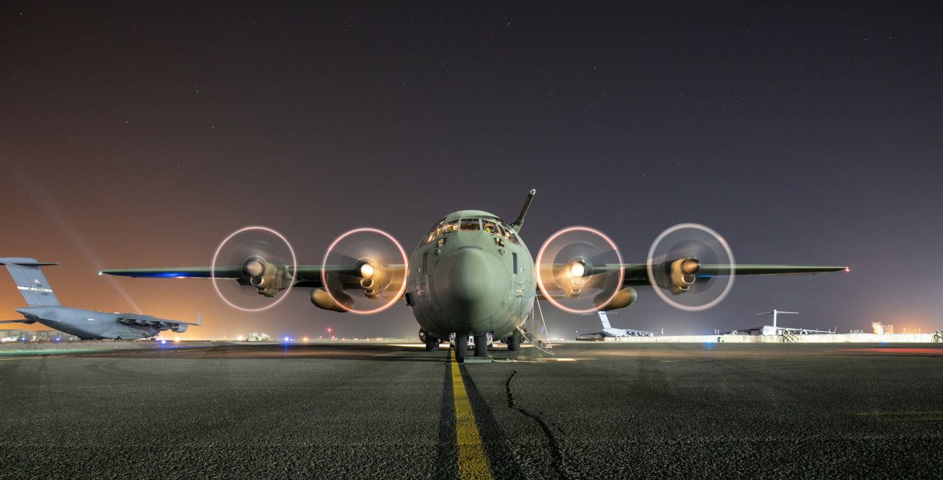 C-130J Hercules on the runway, with lights.