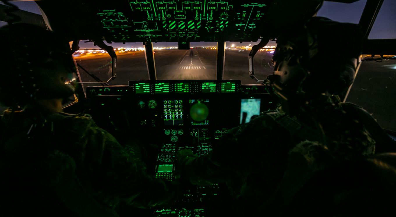 Two pilots inside the cockpit of a C-130J Hercules.