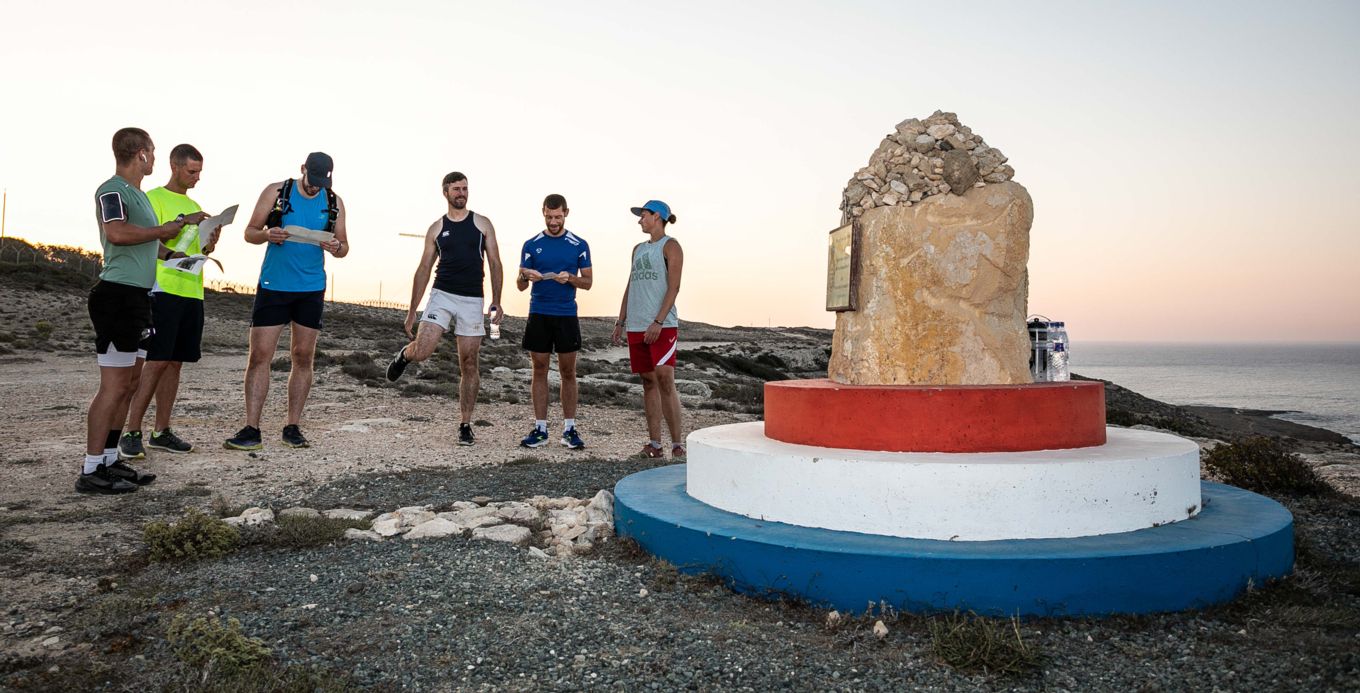 The runners on the trail standing by the Jon Egging memorial.