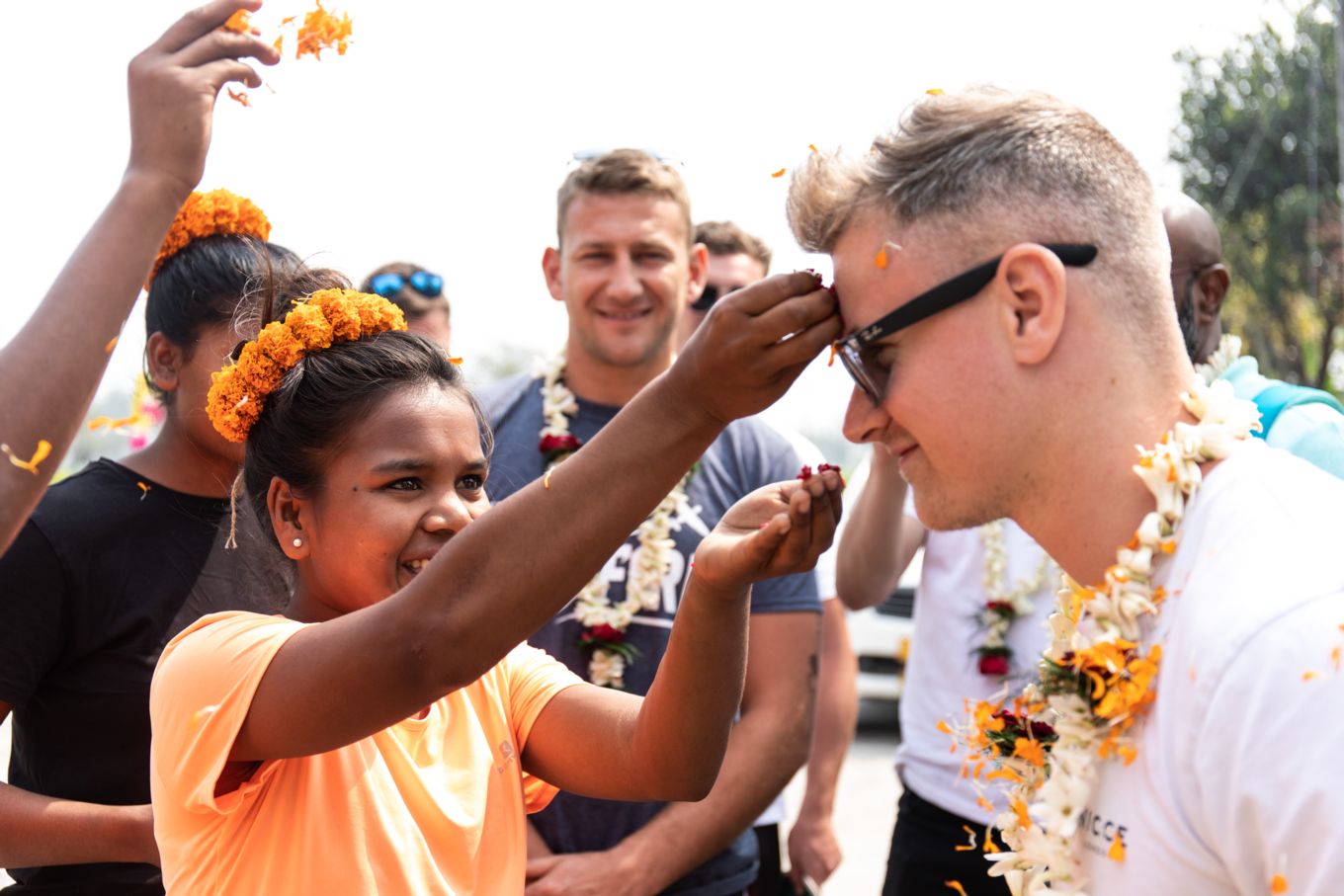 Image shows RAF personnel receiving an arrival blessing.