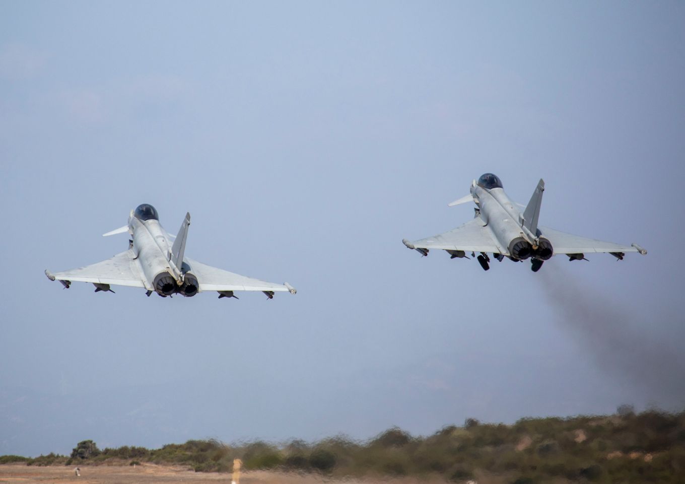 Image shows two RAF Typhoons taking off.