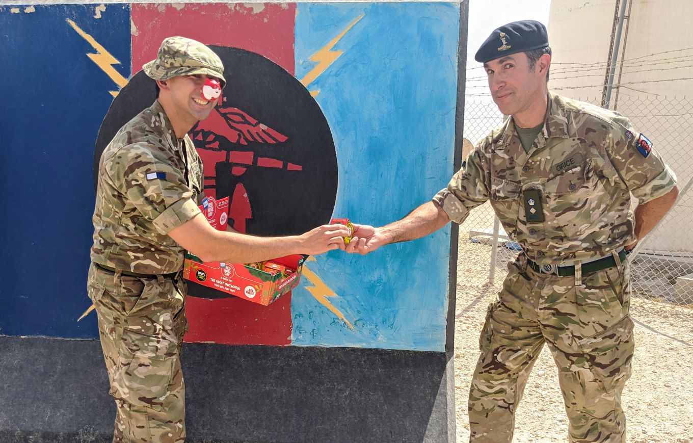 Image shows military personnel wearing red noses.