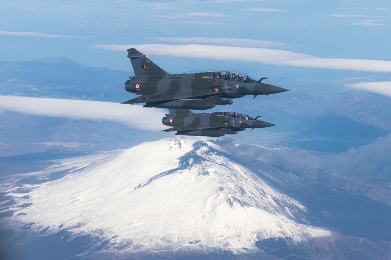 Image shows two French Mirage 2000 aircraft flying.