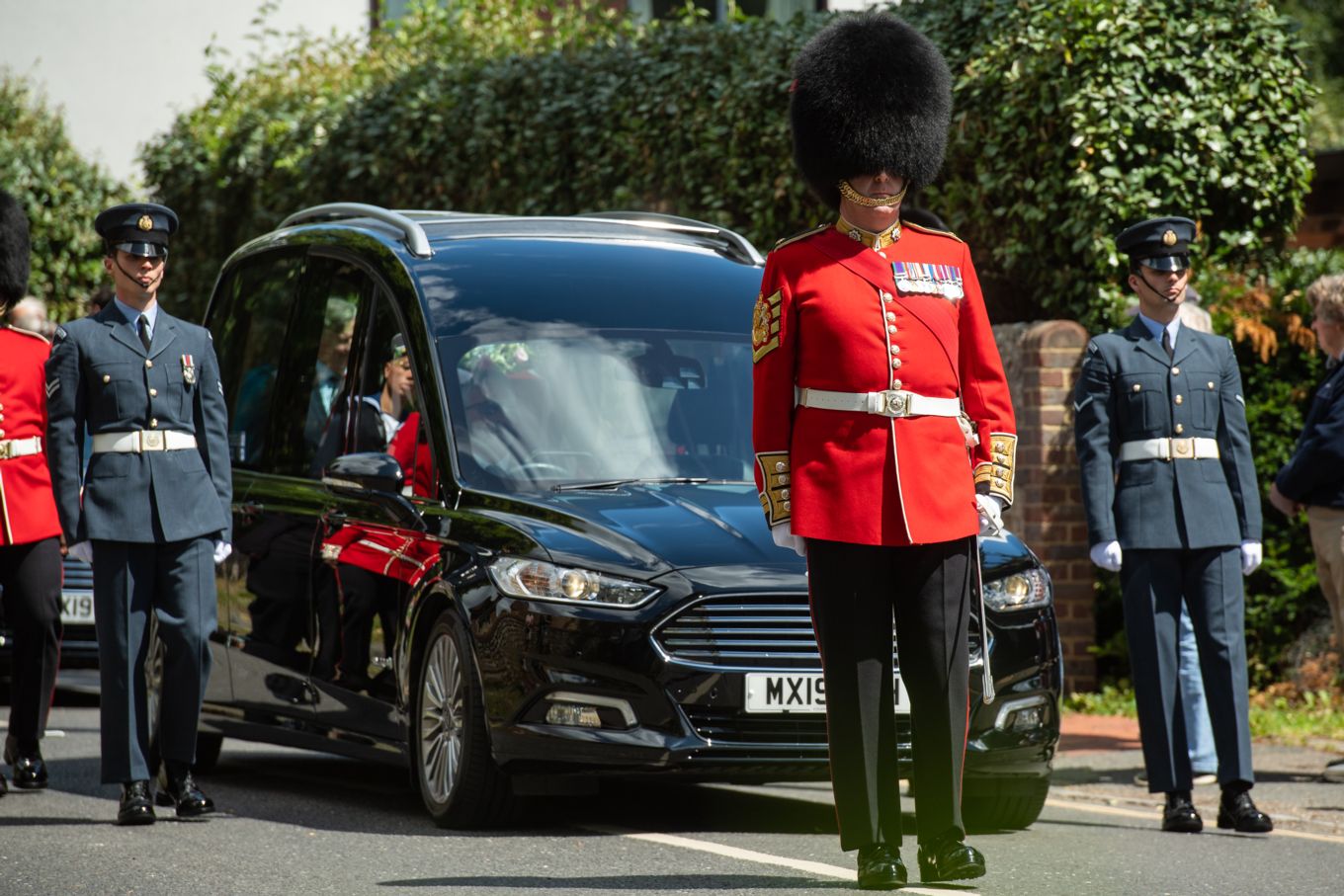 Personnel from all three services walk alongside the hearse carrying Dame Vera’s coffin to the funeral service