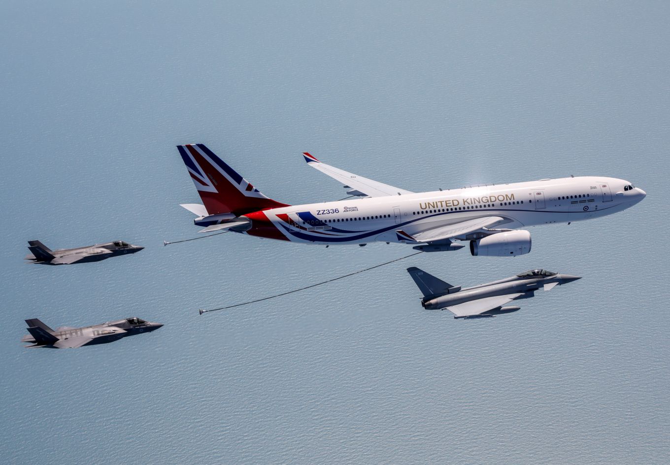 Newly painted RAF Voyager aircraft with Union Flag livery refuelling Typhoon and Lightning aircraft mid-air.