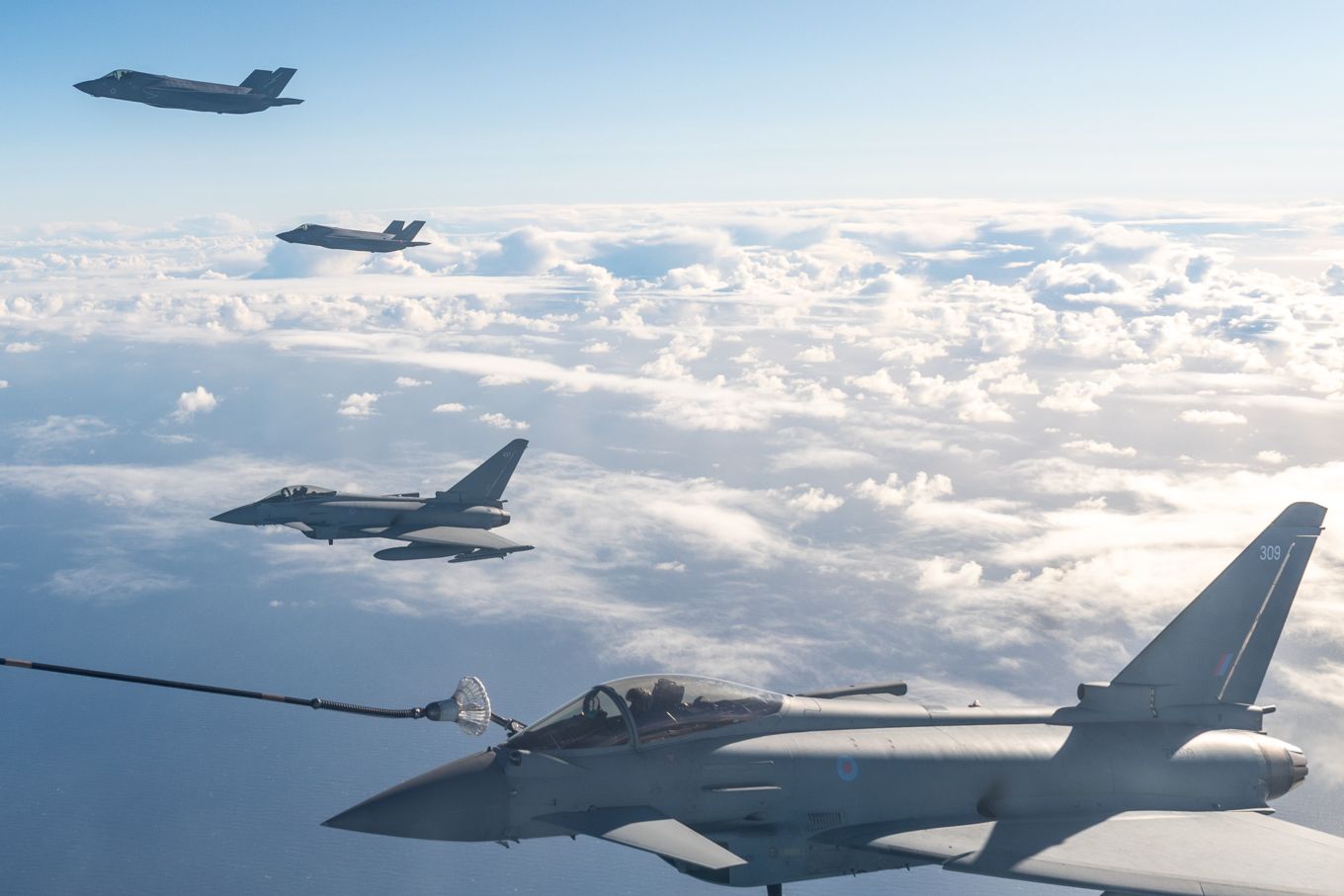 Image shows RAF Typhoons and F-35 Lightning aircraft during air-to-air refuelling.