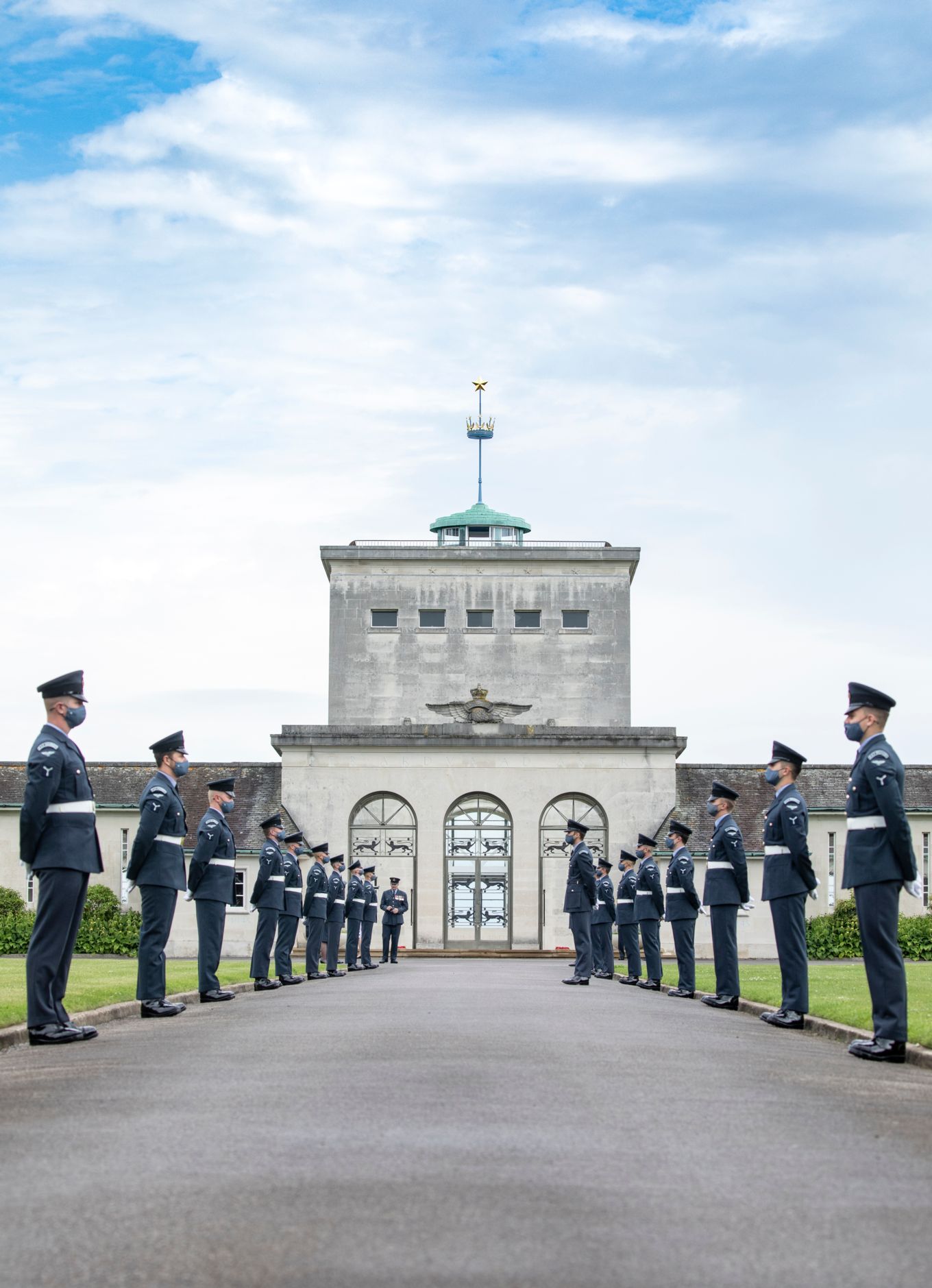 Image show RAF personnel at the Air Forces Memorial, otherwise known as the Runnymede Memorial.