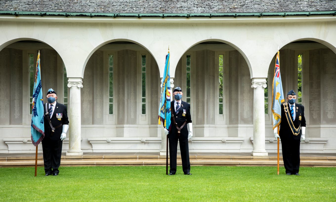 Image shows veterans holding standards (flags). 