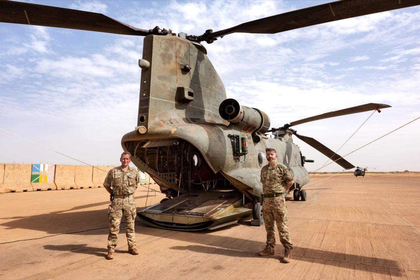 image shows personnel standing next to an RAF Chinook helicopter.