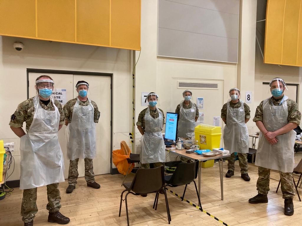 Image shows military personnel at a COVID vaccine centre.