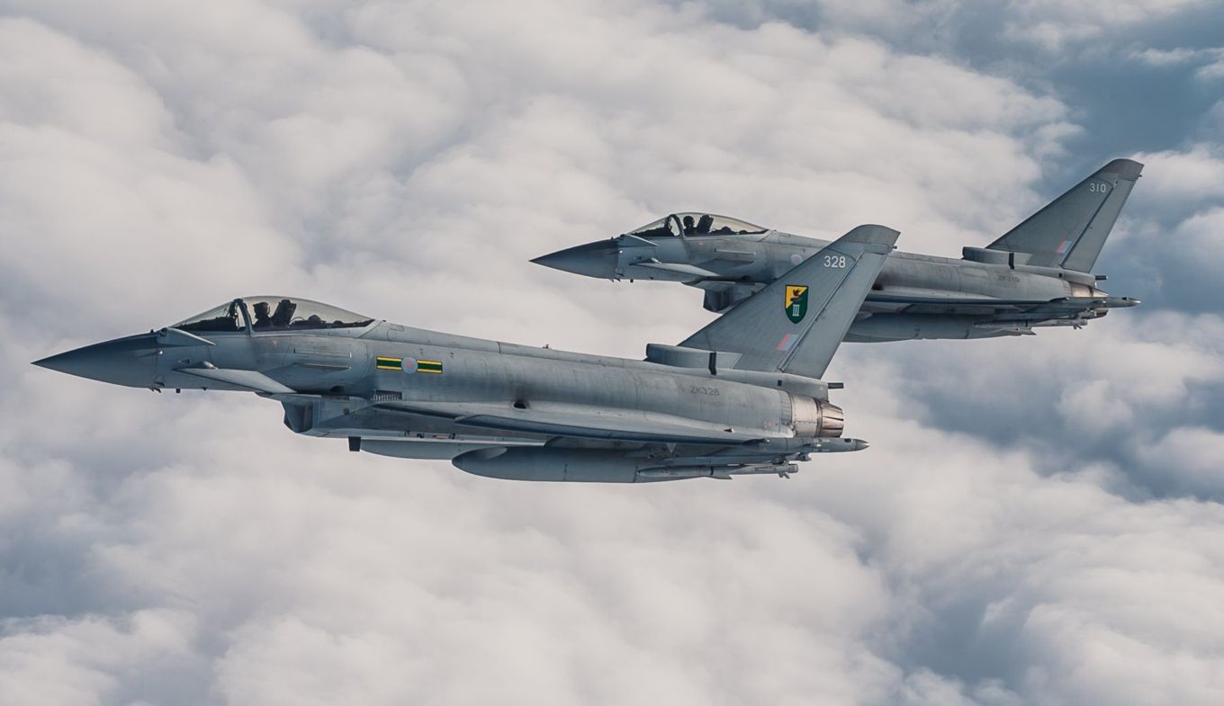 Image shows two RAF Typhoons flying above the clouds.