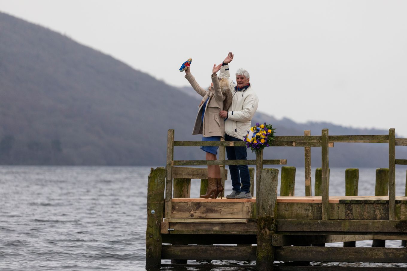 Image shows Donald Campbell's daughter waving at the aircraft flying over Coniston Water.