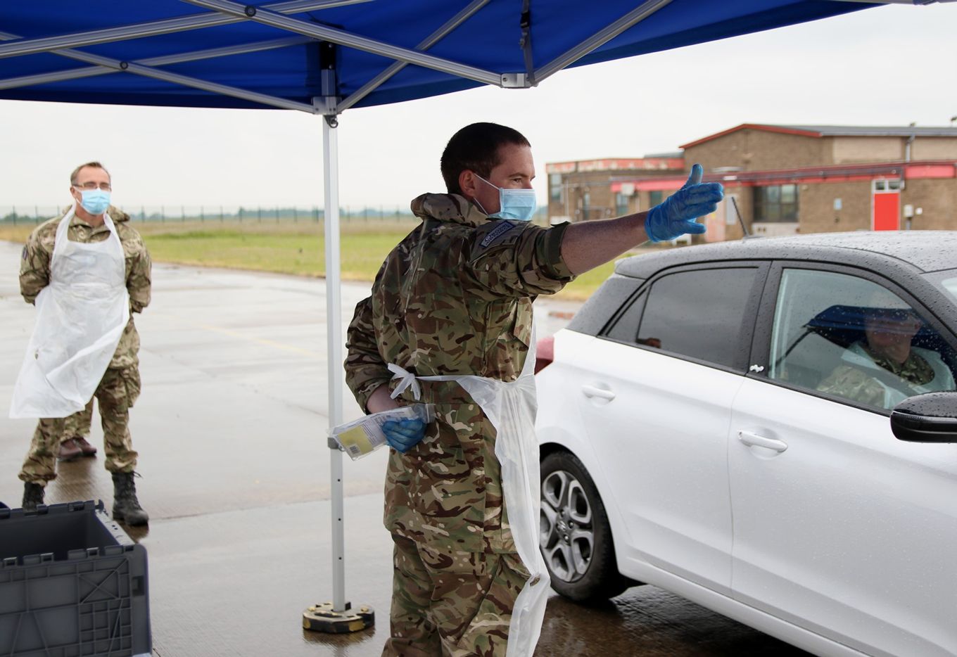 A member of the team directs a vehicle during a run through