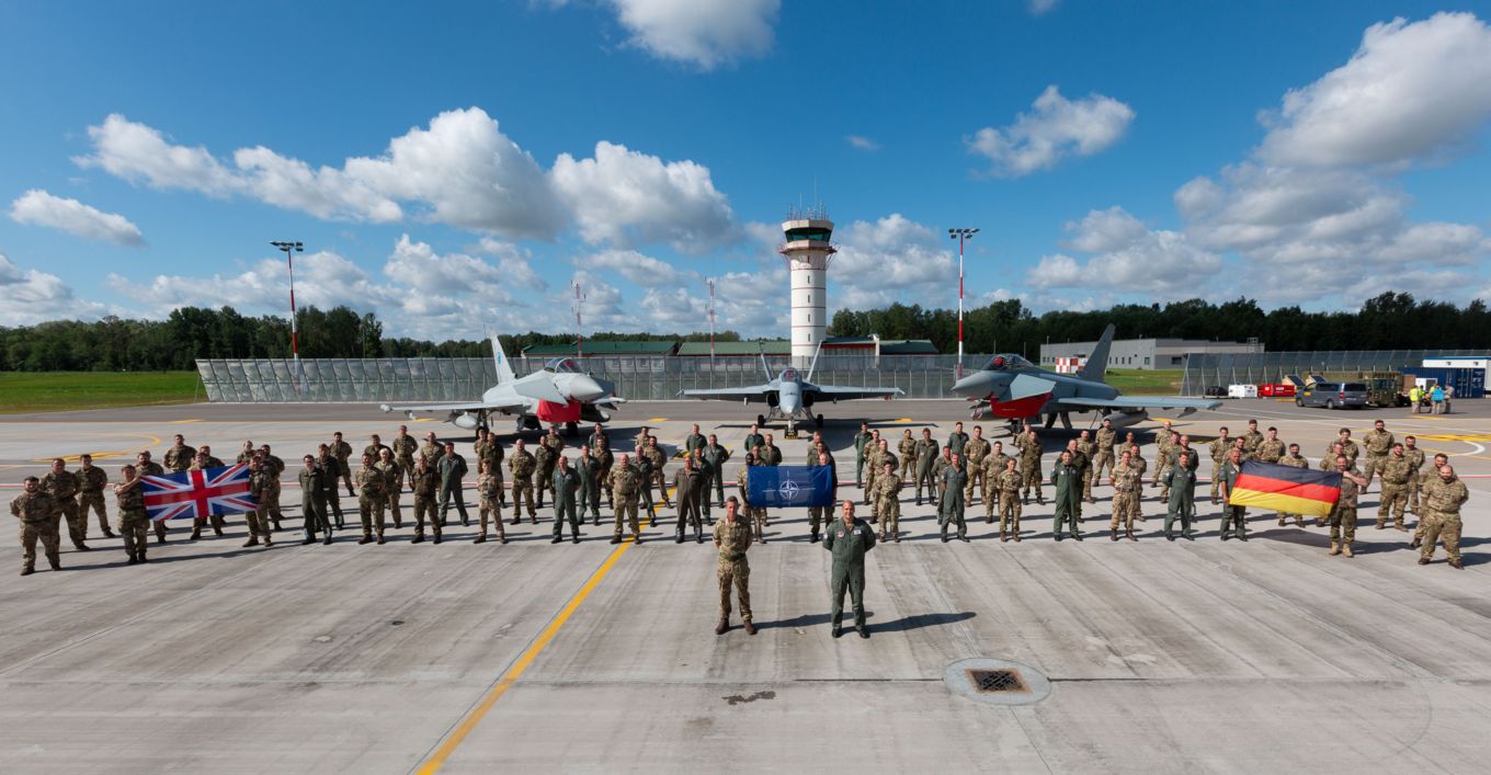 Image shows personnel from the RAF, Spanish Air Force and German Air Force in front of their respective aircraft in Lithuania.
