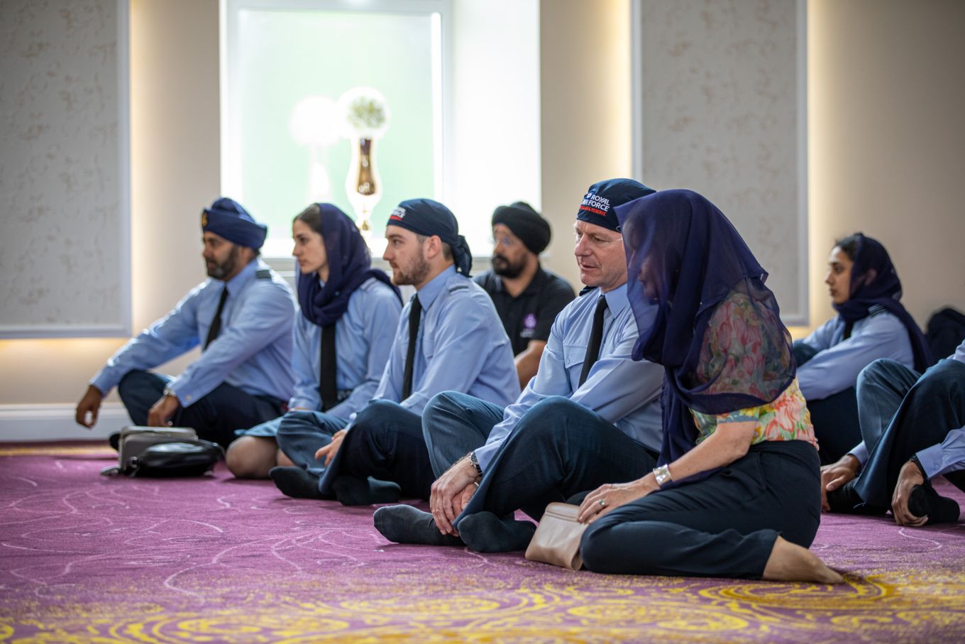 Chief of Air Staff and members of the Sikh community sit cross-legged.