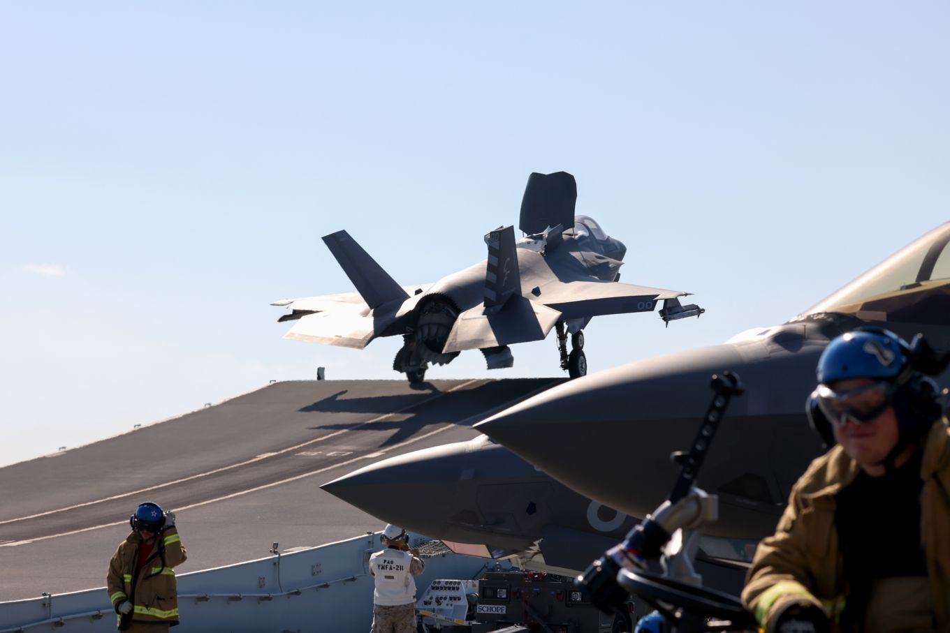 F-35 Lightning jet taking off from HMS Queen Elizabeth, with ground team..
