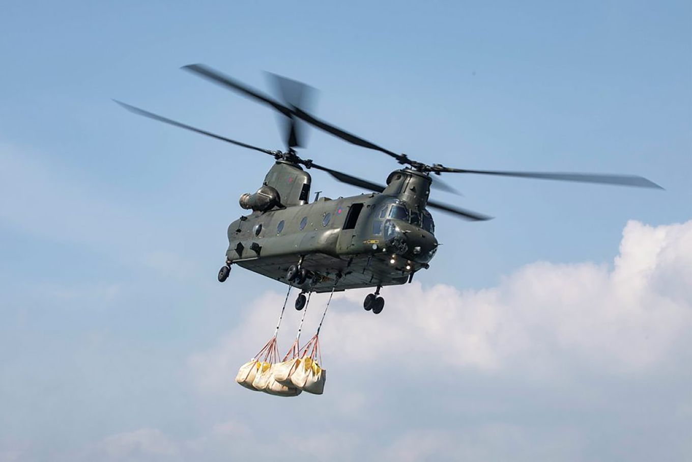 Chinook in flight with load sling. 