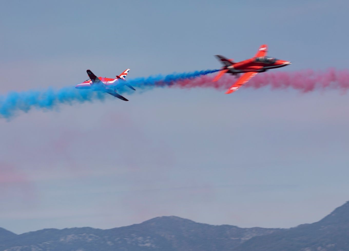 Two Red Arrows with blue and red trails.