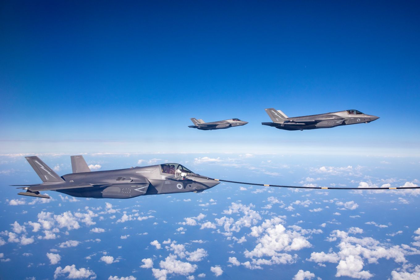 Image shows RAF F-35B Lightning conducting air to air refuelling over the sea.