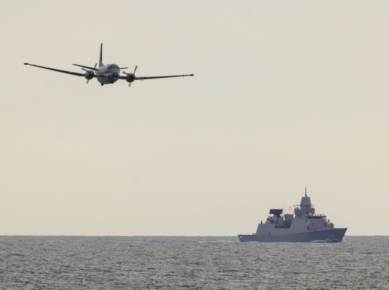 Long shot of a the Dutch destroyer warship and a French MPA Aircraft.