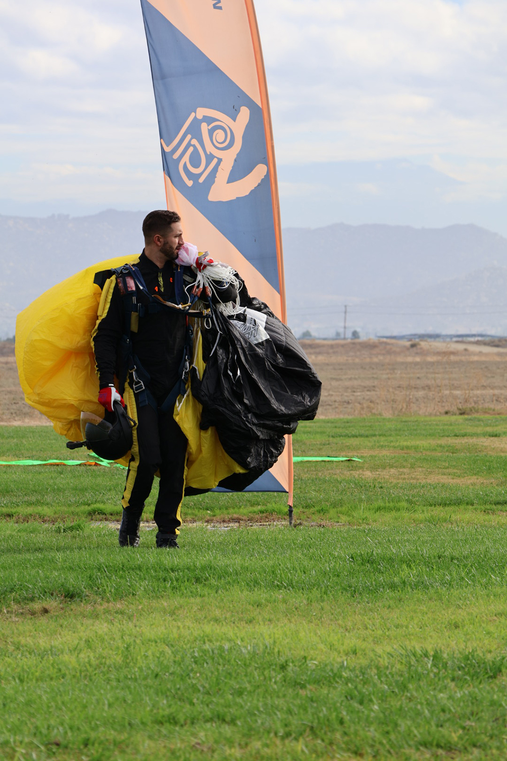 Sergeant Luke Mees, having gathered his parachute after a jump stands adjacent to the landing zone.