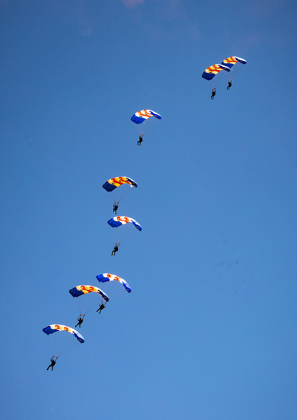 Decoration: Photo - Eight members of the RAF Falcons continue to descend in a loose 'stack' as they come in for a landing after completing their display. They are no longer trailing smoke.