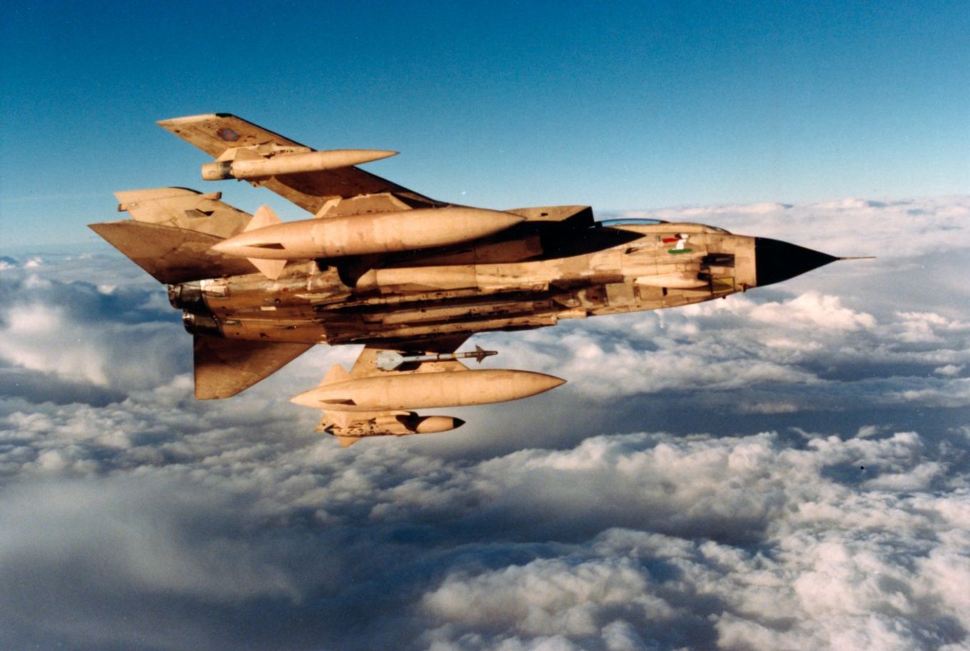 Image shows an RAF Tornado aircraft flying above the clouds.