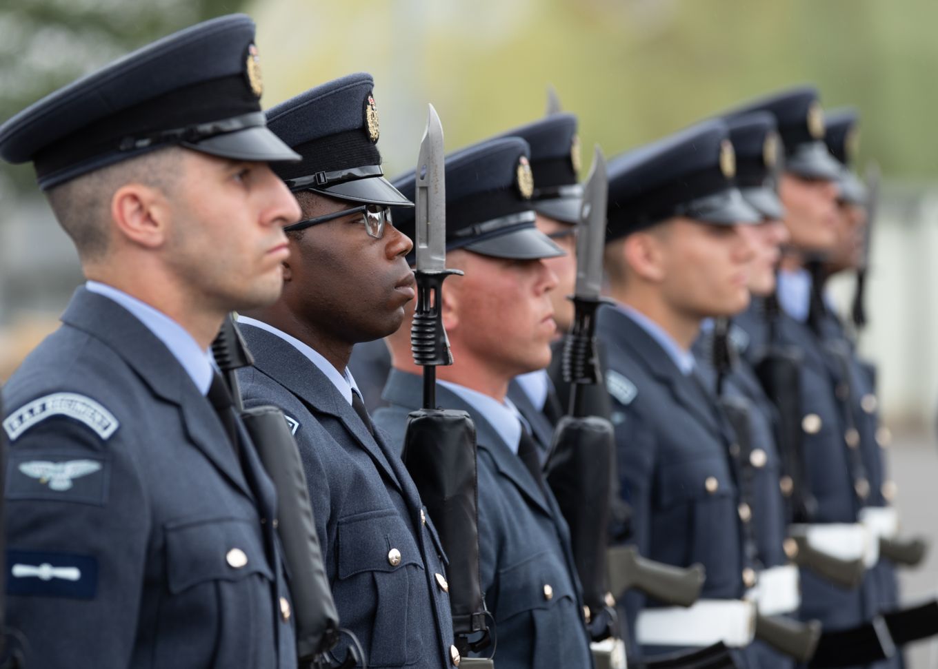 Graduates hold rifles during parade.