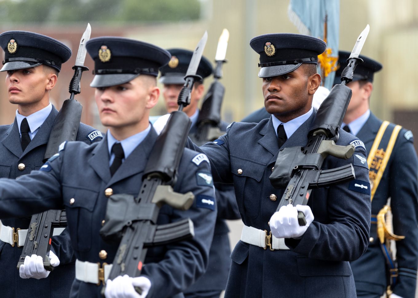 Graduates hold rifles during parade.