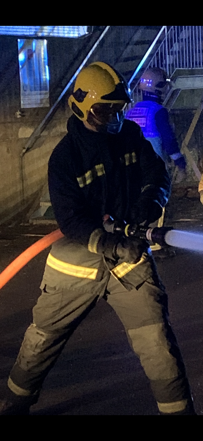 RAF Firefighter in training with water hose