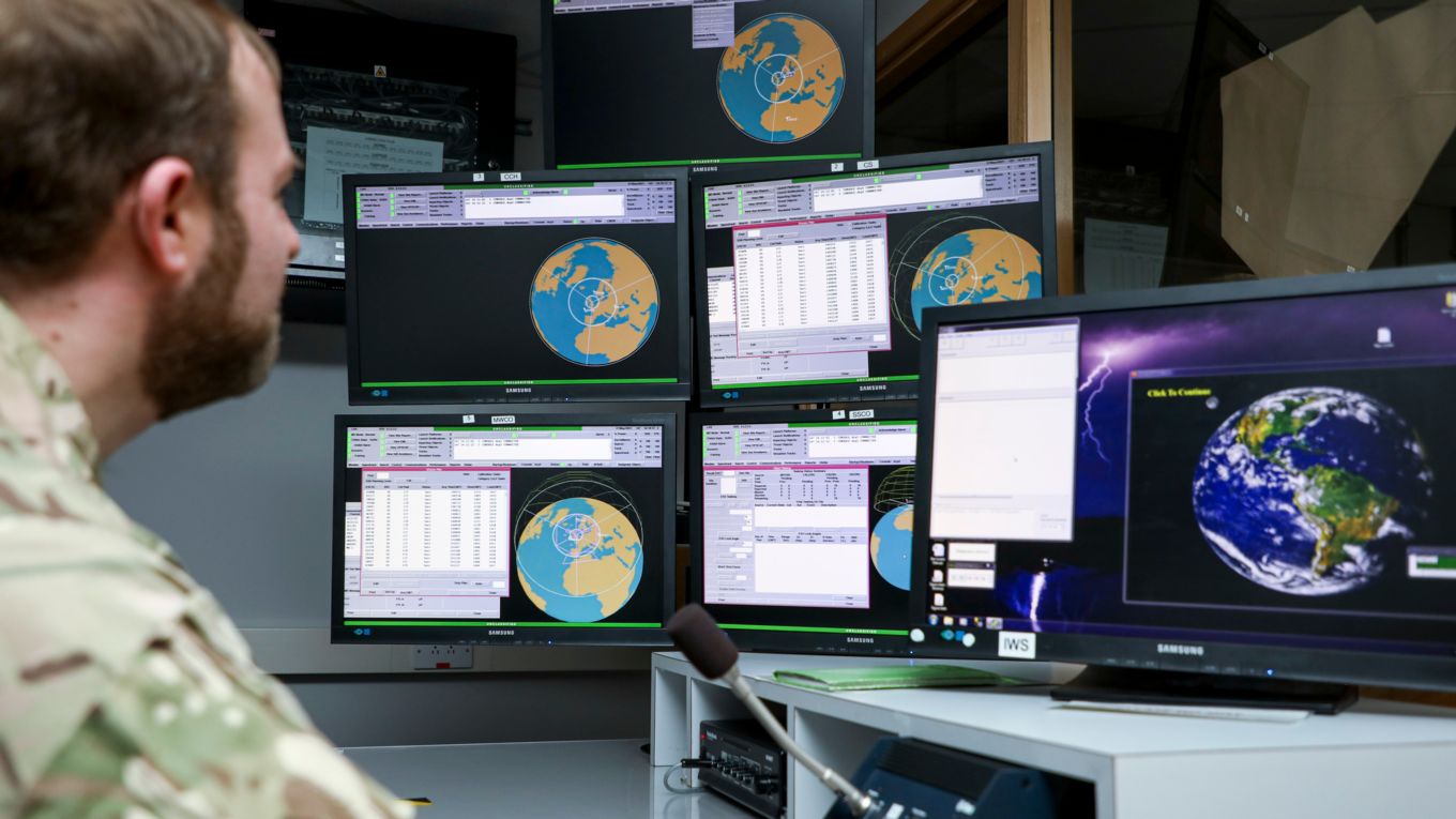 Personnel looking at computer screens in the Space Operations Room.